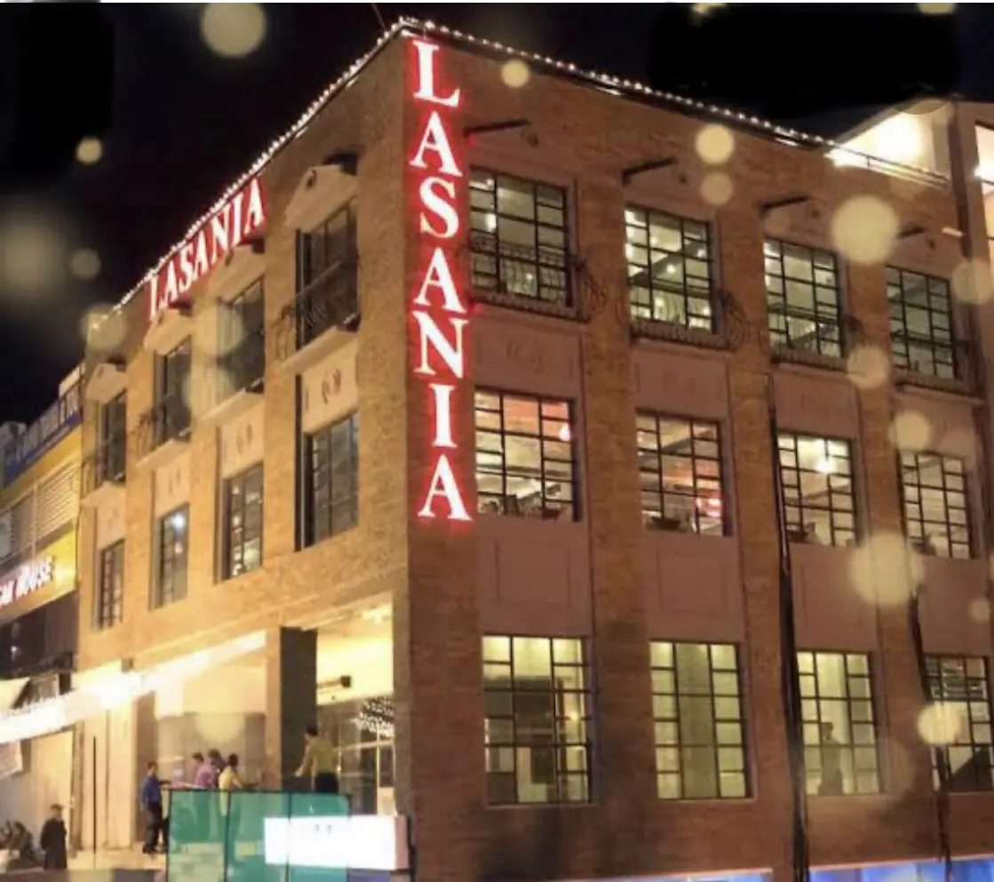 The Lasania building on Murree Road at night, with the red Lasania sign