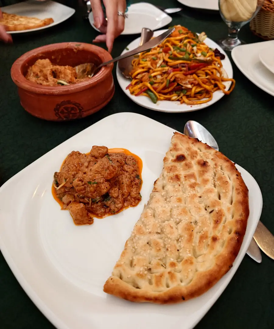 A table at Lasania with handi, naan and chow mein